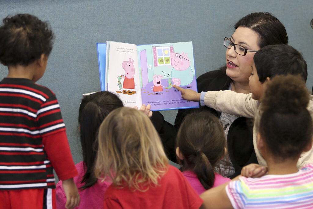 Woman reading to children