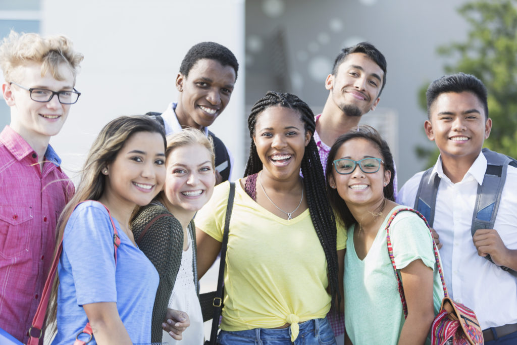 Multi-ethnic group of teenagers at school, outdoors