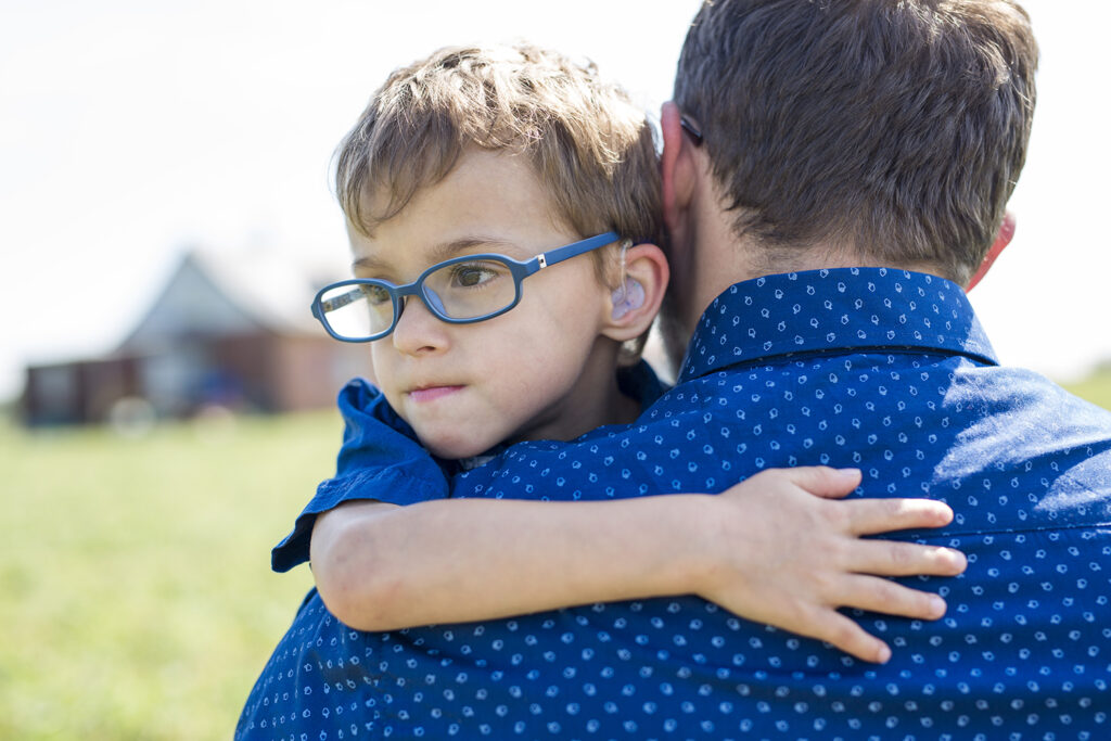 A Father And Son Hugging On Outdoor summer