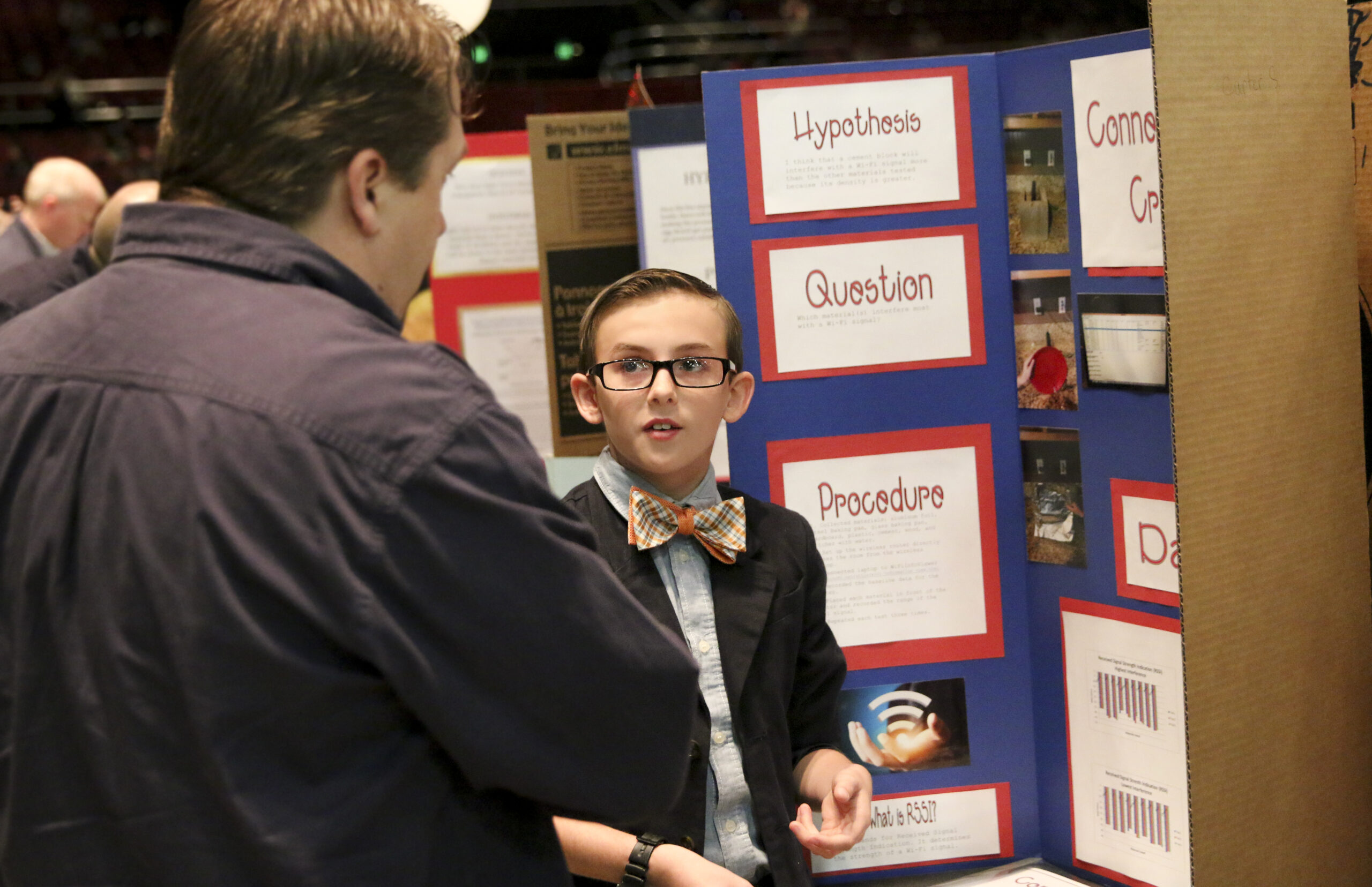 Teen showing his Science Fair project