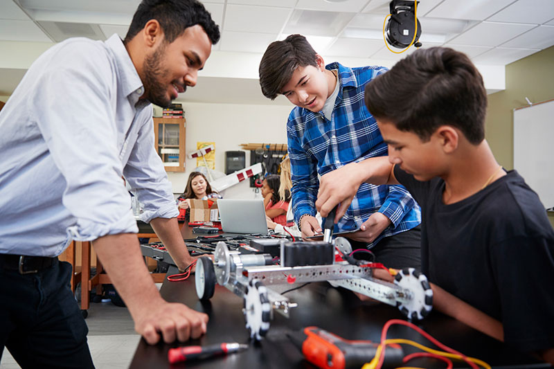 Teens working on a robot