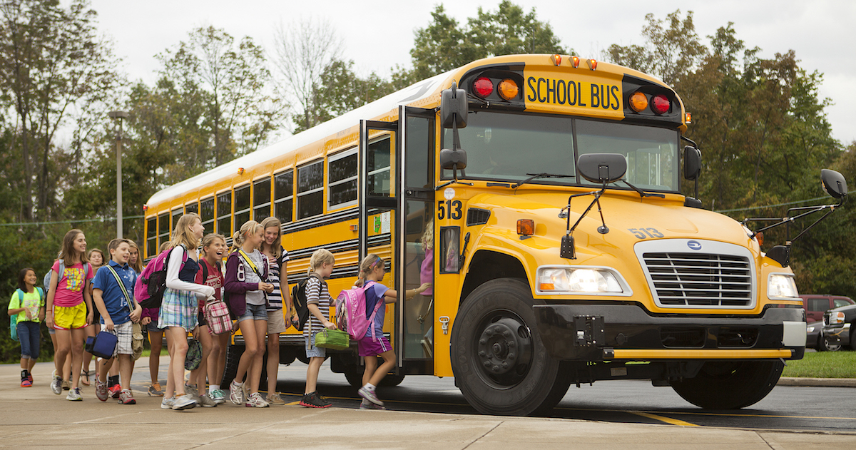 Students loading the yellow school bus