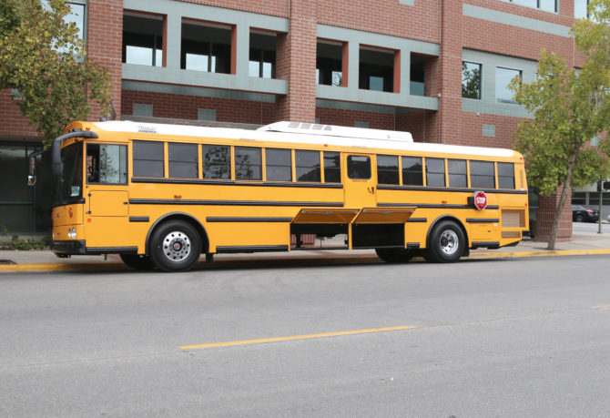 KCSOS charter-style school bus with storage opened
